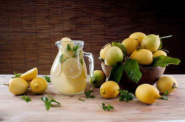 Lemonade with mint in a jar and lemon on the table